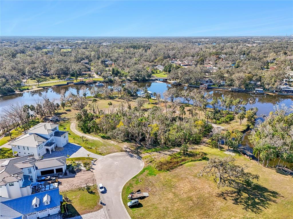 An aerial view shows a waterfront property with two large houses and a cul-de-sac — 8331 ALAFIA POINTE DRIVE, RIVERVIEW, FL