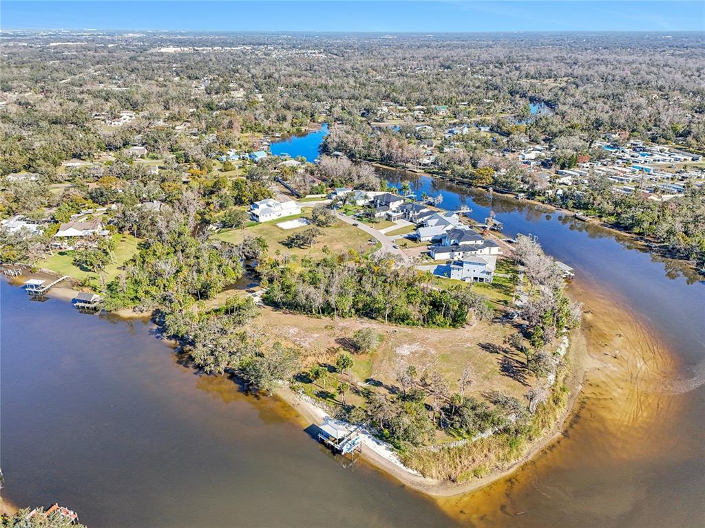 An aerial view shows a waterfront residential peninsula with several houses and a boat dock — 8331 ALAFIA POINTE DRIVE, RIVERVIEW, FL