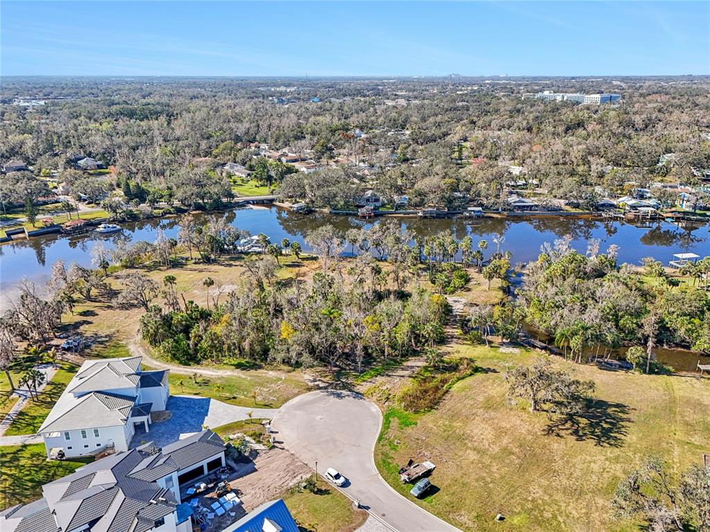 An aerial view shows a modern house, a cul-de-sac, and a river with surrounding trees — 8331 ALAFIA POINTE DRIVE, RIVERVIEW, FL