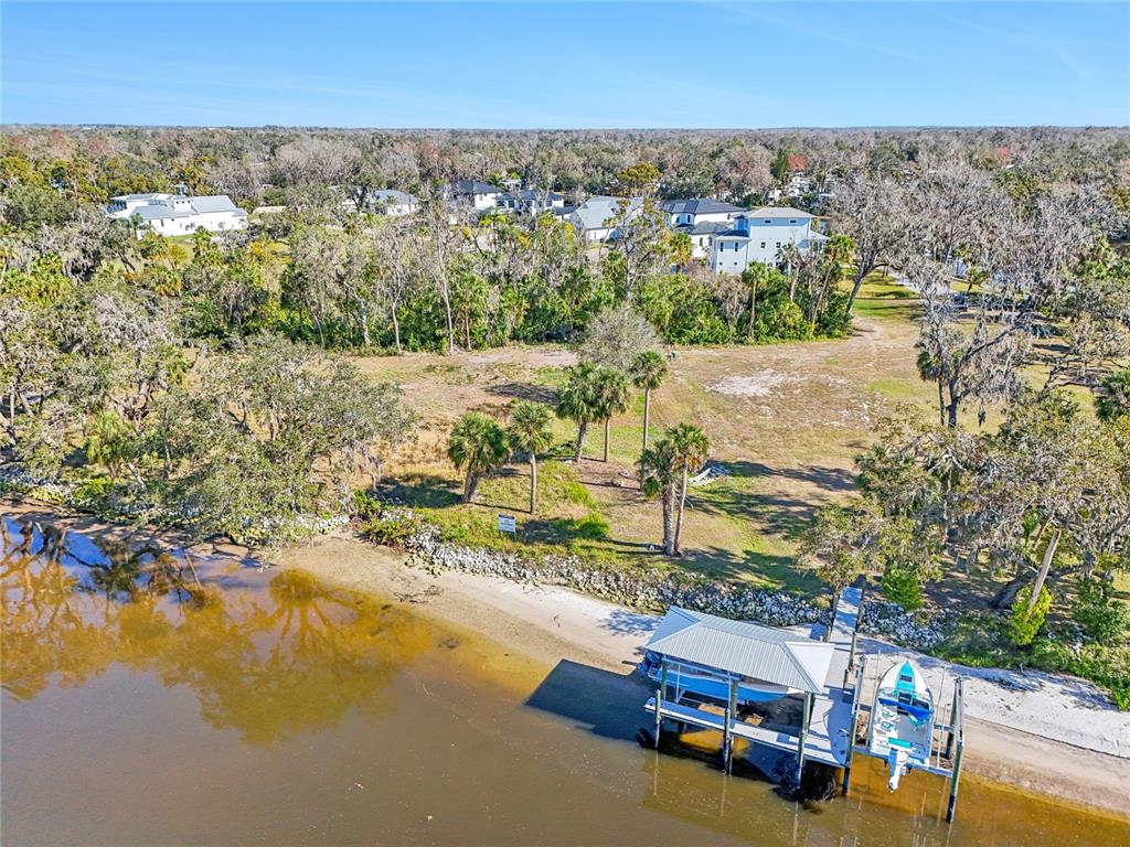 An aerial view shows a waterfront lot with a boat dock and a covered slip — 8331 ALAFIA POINTE DRIVE, RIVERVIEW, FL
