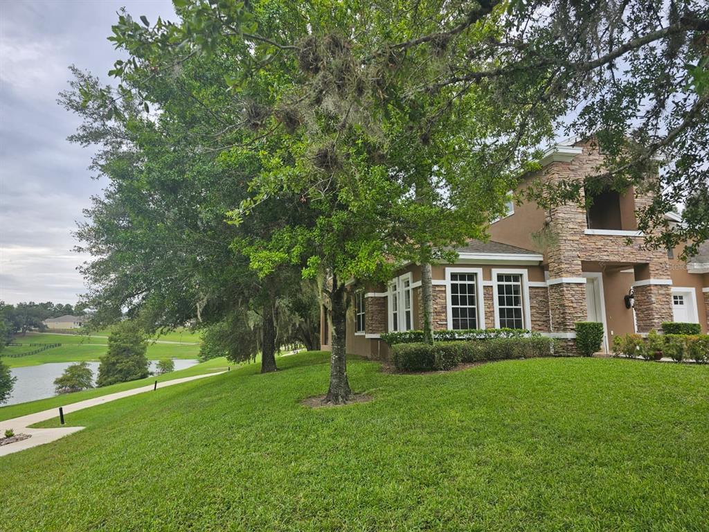 An interior view shows a dining area and living space connected by arched doorways — 21632 HIDDEN CREEK, MOUNT DORA, FL