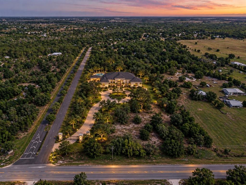 An aerial view shows a wooded plot of land marked with a house icon — SR-64 E, MYAKKA CITY, FL