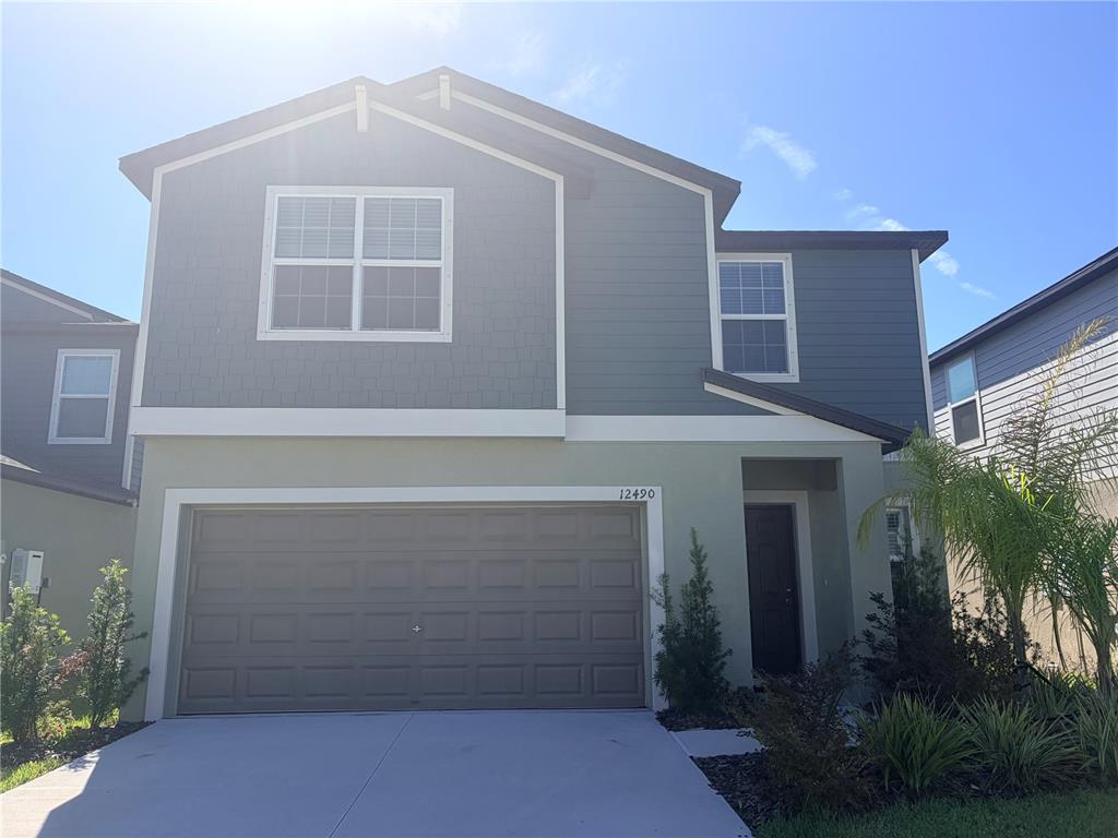 A two-story house with a gray exterior, a two-car garage, and a front entrance — 12490 SWEET ANGEL AURA WAY, PARRISH, FL