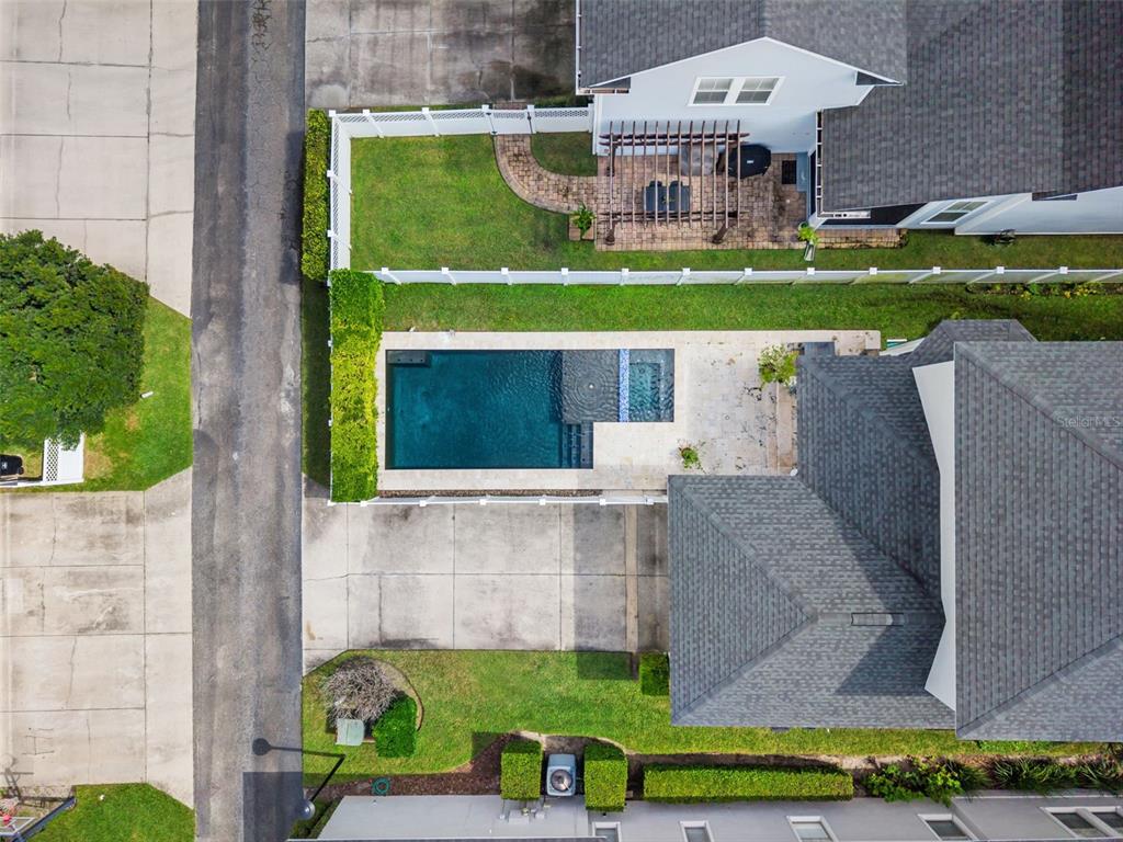 An aerial view shows a house with a swimming pool, patio, and fenced backyard — 5165 FENWOOD LANE, ORLANDO, FL
