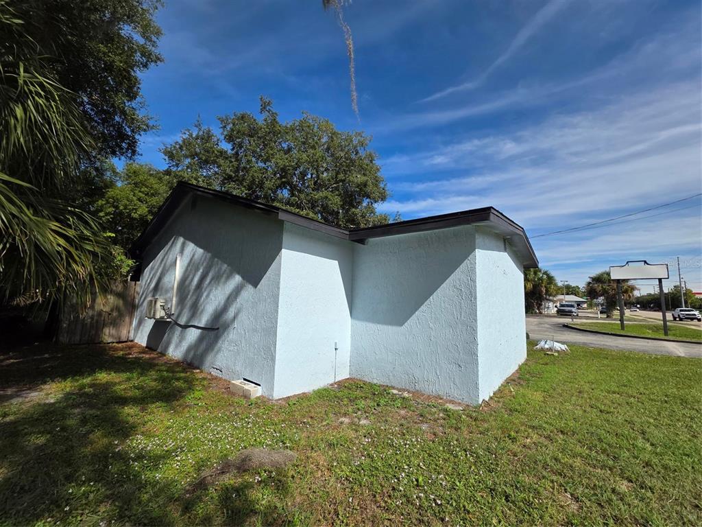 A light blue stucco building exterior with a flat roof sits on a grassy lot — 217 E STATE ROAD 434, LONGWOOD, FL