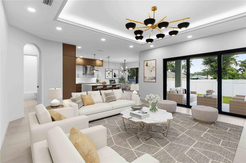 A modern living room with white sofas, a geometric rug, and a gold chandelier — 104 S MAKI ROAD, PLANT CITY, FL