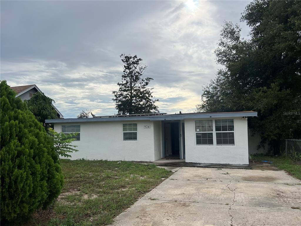 A single-story white house with a flat roof and a concrete driveway — 924 FERNDELL ROAD, ORLANDO, FL