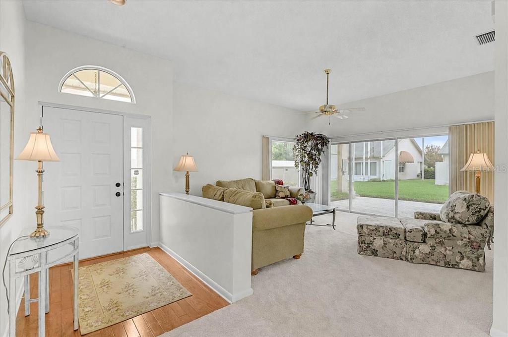A single-story suburban house with a tile roof, a two-car garage, and a manicured lawn — 4717 PERIDIA BOULEVARD E, BRADENTON, FL