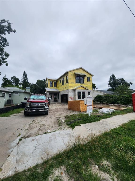 A construction site shows a concrete foundation slab with vertical rebar and block wall footings — 751 40TH AVENUE N, ST PETERSBURG, FL