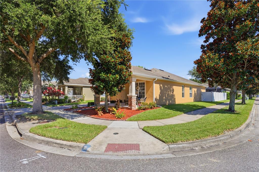 A single-story house with a tan exterior and a front porch sits on a corner lot — 13231 ROXBORO ROAD, WINDERMERE, FL