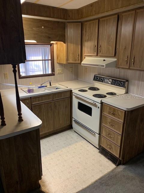 A bedroom features wood-paneled walls, a mirrored sliding closet, built-in drawers, and gray carpeting — 3000 CLARCONA ROAD UNIT 616, APOPKA, FL