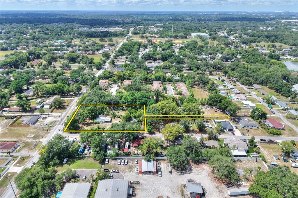 An aerial view shows a residential lot outlined in yellow within a suburban neighborhood — 5310 S 579 HIGHWAY, SEFFNER, FL