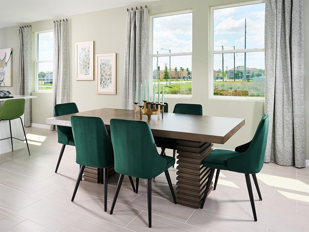 A dining room features a wooden table, green velvet chairs, and large windows with curtains — 3960 GIORGIO DRIVE, WINTER HAVEN, FL