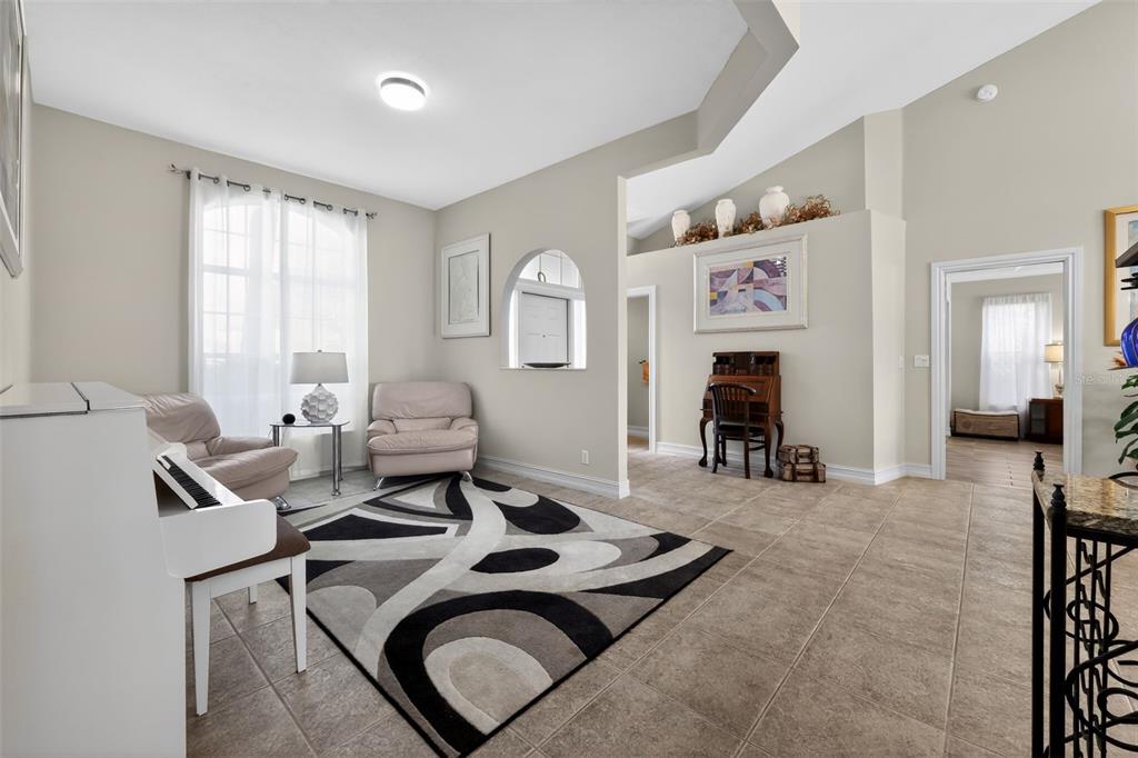 A living room features a white piano, two armchairs, a patterned rug, and tiled floors — 12301 CABOT COURT, BOCA RATON, FL