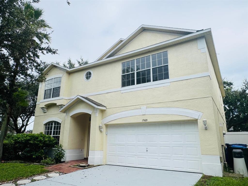 A room with wood-look flooring, a ceiling fan, and a large mirrored closet wall — 13621 TETHERLINE TRAIL, ORLANDO, FL