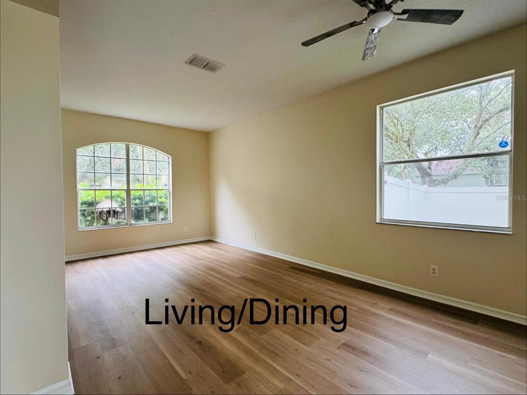 A straight staircase with wood-look treads and white risers leads to an upper landing — 13621 TETHERLINE TRAIL, ORLANDO, FL