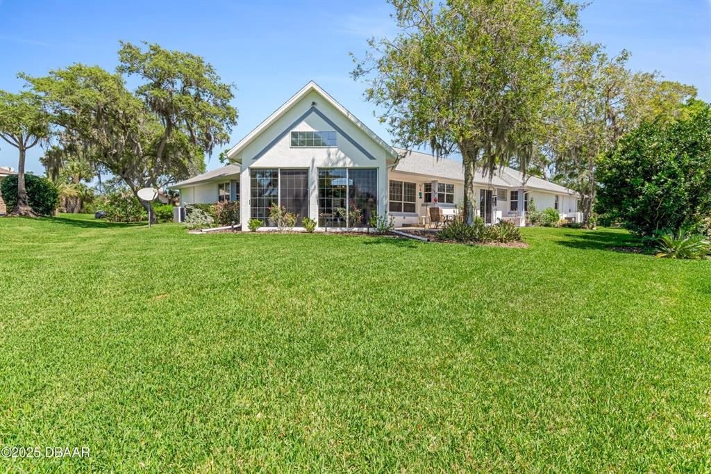 A view of a pond and manicured green lawn on a golf course — 203 PRESTWICK DRIVE, NEW SMYRNA BEACH, FL