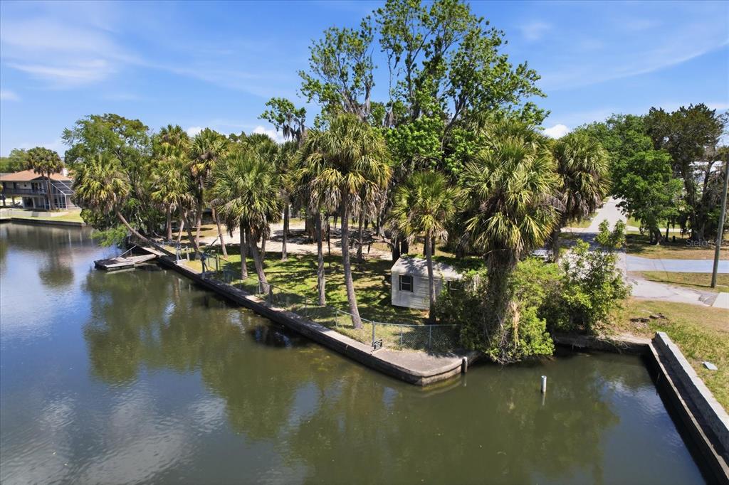 An aerial view shows a waterfront property with a house, trees, and a boat dock — 1941 NW 16TH STREET, CRYSTAL RIVER, FL