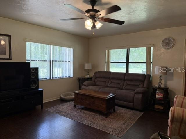 A living room features a brown sofa, a wooden coffee table, and a ceiling fan — 14236 SW 76TH WAY, LAKE BUTLER, FL