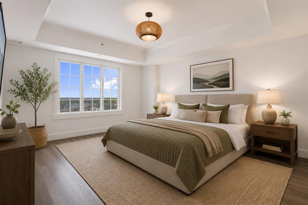A bedroom features a king bed, tray ceiling, woven light fixture, and large windows — 7593 GATHERING DRIVE UNIT 707, REUNION, FL