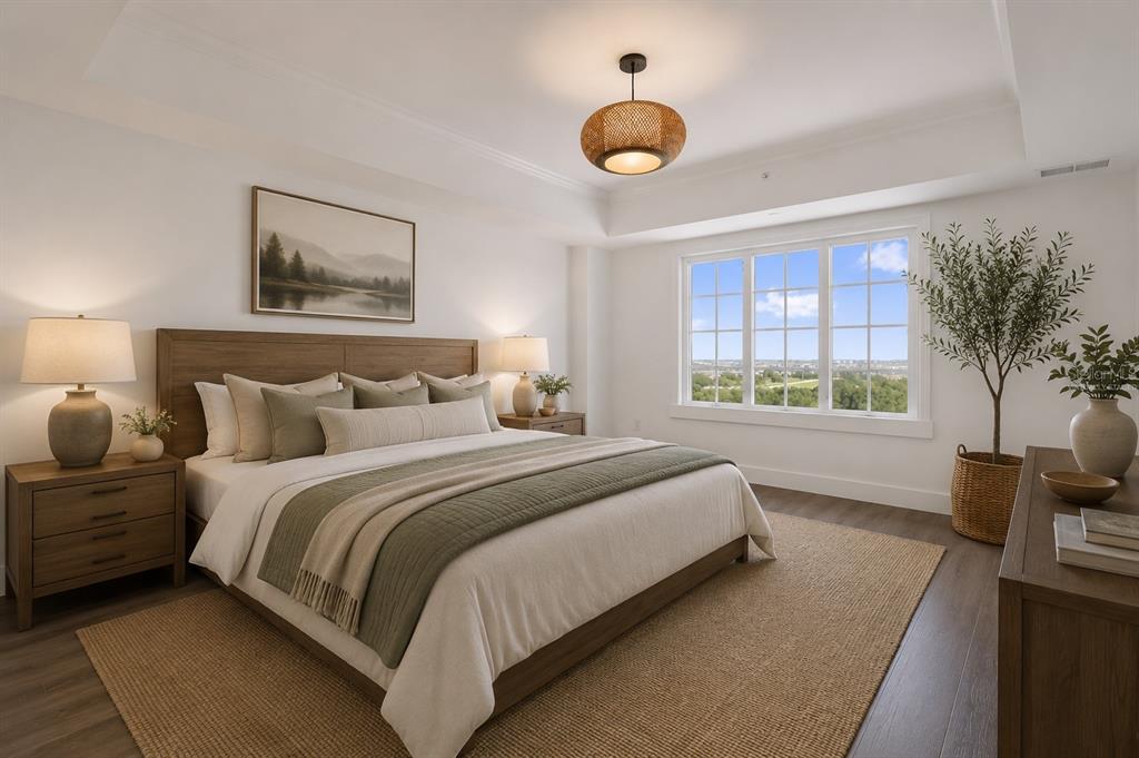 A bedroom features a wooden bed frame, a woven rug, and a large window with views — 7593 GATHERING DRIVE UNIT 707, REUNION, FL