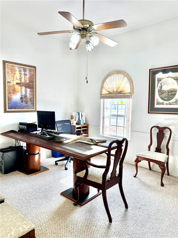 A home office features a large wooden desk, a ceiling fan, and two framed pictures — 2605 BAYVIEW STREET, SEBRING, FL