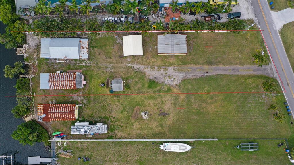 An aerial view shows three waterfront lots with houses, sheds, and a boat — 3312 W SHELL POINT ROAD, RUSKIN, FL