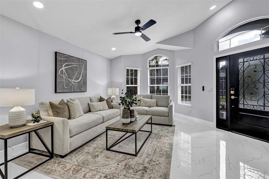 A living room features light gray walls, a white tile floor, and a black front door — 13712 DEVLIN COURT, ORLANDO, FL