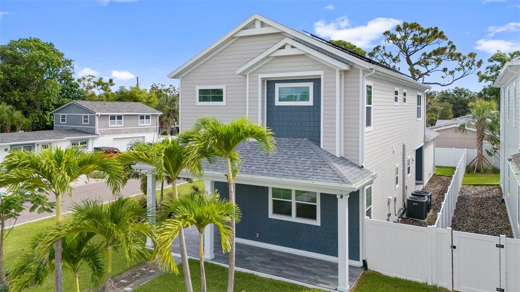 A two-story house with light gray siding, blue accents, and a covered front porch — 3839 71ST STREET N, ST PETERSBURG, FL