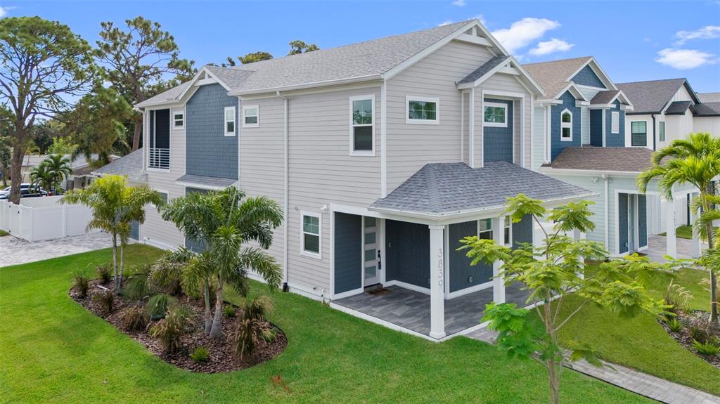 A two-story house with gray siding, blue accents, and a covered front porch — 3839 71ST STREET N, ST PETERSBURG, FL