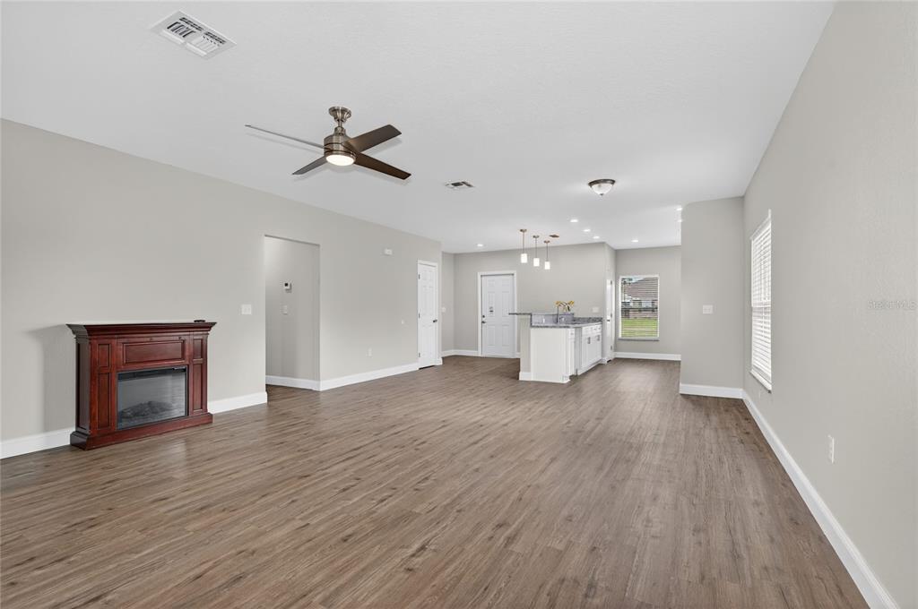 A yellow single-story house with a white metal roof and a two-car garage — 2581 POINCIANA DRIVE, INDIAN LAKE ESTATES, FL