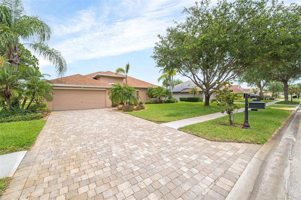 A single-story house with a paved driveway, a two-car garage, and a landscaped front yard — 241 DEVLIN COURT, PALM BAY, FL