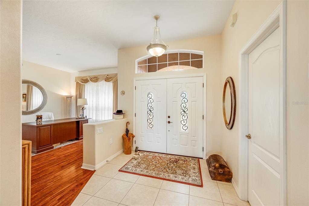 An entryway with tile flooring, a double front door, and an adjacent office area — 241 DEVLIN COURT, PALM BAY, FL