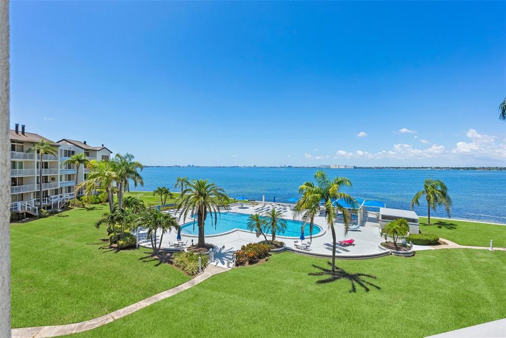 An aerial view shows a waterfront condominium complex with a pool and a red arrow — 5155 ISLA KEY BOULEVARD S UNIT 304, ST PETERSBURG, FL