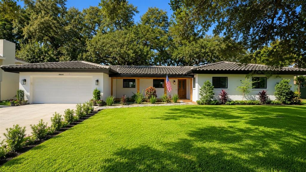 A single-story house with a white exterior, a tiled roof, and a large front lawn — 2218 HENNESEN DRIVE, CLEARWATER, FL