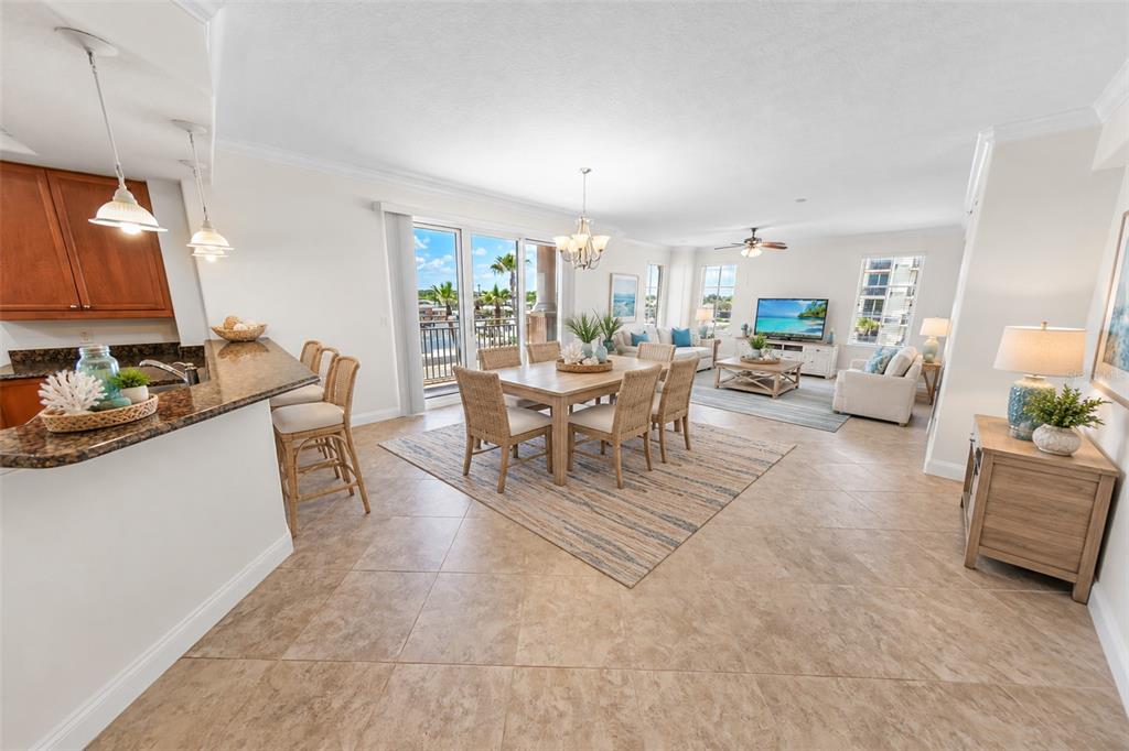 An open-concept dining and living area features tile flooring, a fireplace, and a chandelier — 2515 S ATLANTIC AVENUE UNIT 301, DAYTONA BEACH, FL