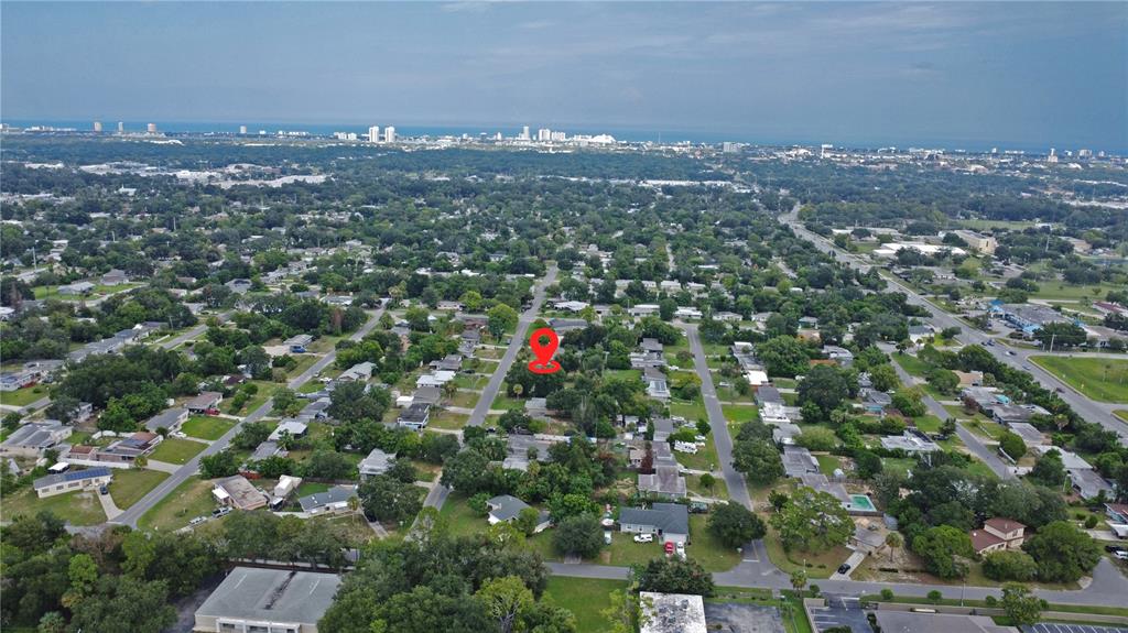 An aerial view shows a residential neighborhood with a red location pin marking a property — 1311 HILLCREST DRIVE, DAYTONA BEACH, FL