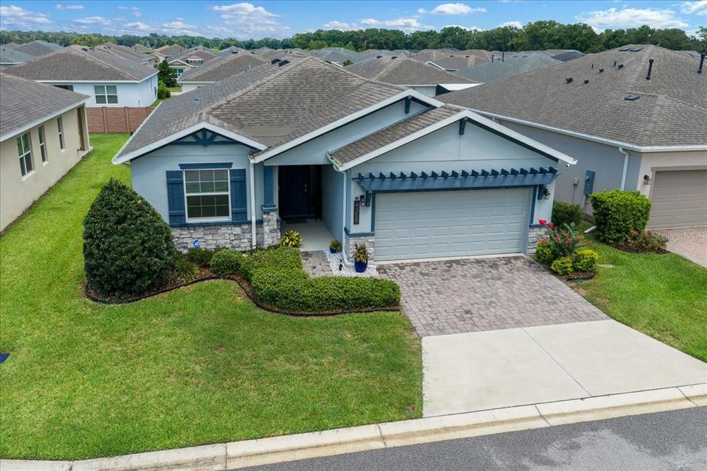 An aerial view of a single-story suburban house with a blue exterior and stone accents — 4355 NW 55TH TERRACE, OCALA, FL