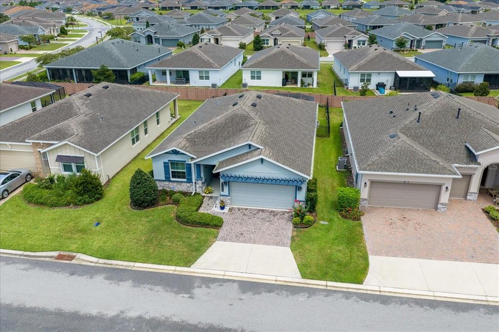 An aerial view shows a suburban house with a gray roof and paved driveway — 4355 NW 55TH TERRACE, OCALA, FL