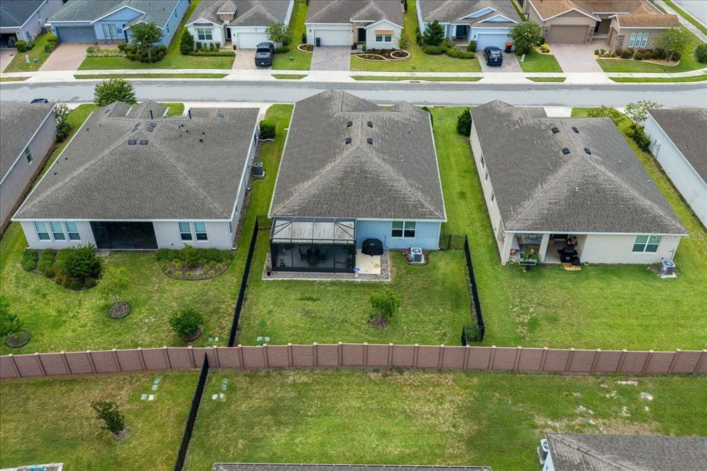 An aerial view shows three suburban houses with fenced backyards and a shared street — 4355 NW 55TH TERRACE, OCALA, FL