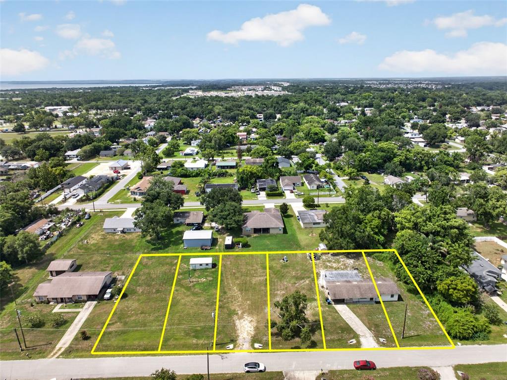 An aerial view shows several adjacent residential lots, some vacant and some with houses — 212 15TH AVENUE, OCOEE, FL