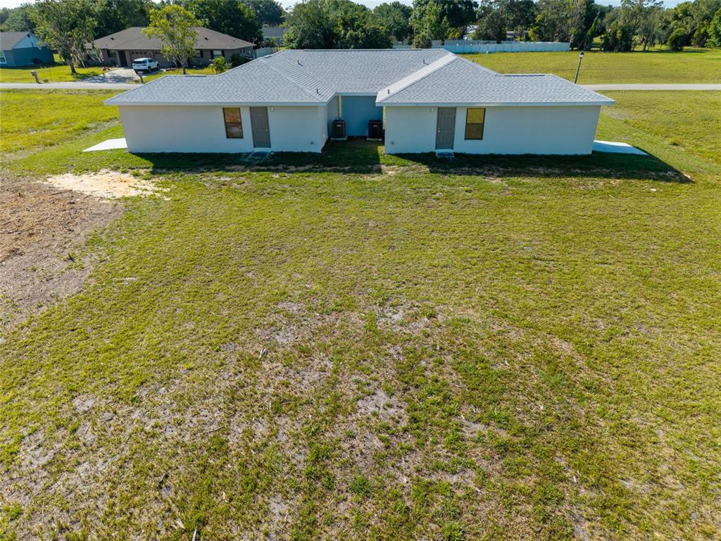 A kitchen features white cabinets, granite countertops, a stainless steel sink, and a black stove — 6301 CANDLER TERRACE, SEBRING, FL