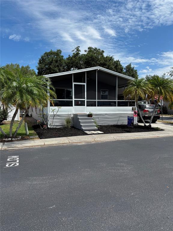 A sign for Lake Fantasia stands in front of a palm tree and paved road — 8330 FANTASIA PARK WAY, RIVERVIEW, FL