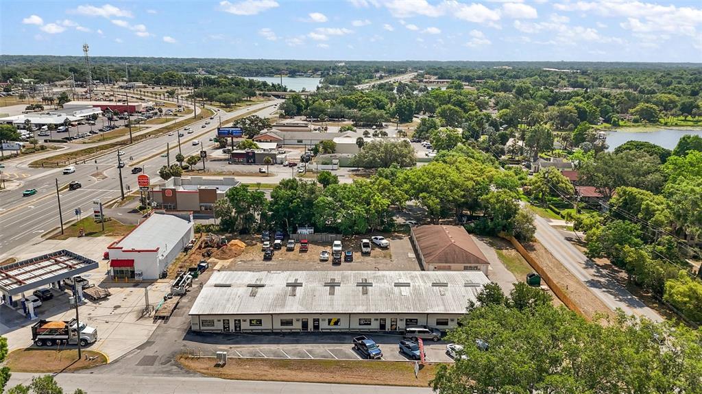 An aerial view shows a commercial building with a parking lot near a busy road — 3101 KURT STREET, EUSTIS, FL