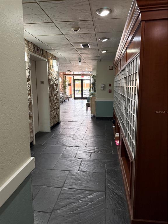 A pool table sits in the center of a room with beige walls and carpet — 17920 GULF BOULEVARD UNIT 1203, ST PETERSBURG, FL
