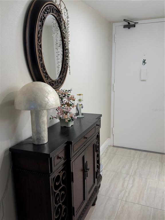 A gym room features various exercise machines, a drop ceiling, and light-colored walls — 17920 GULF BOULEVARD UNIT 1203, ST PETERSBURG, FL