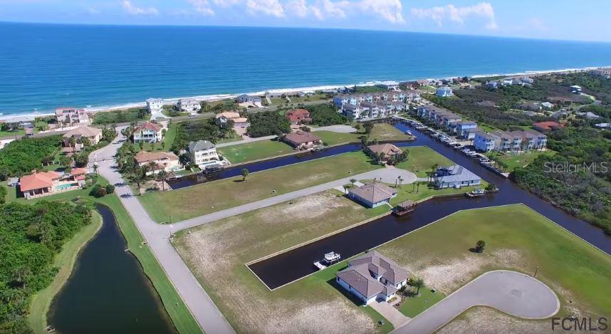 An aerial view shows coastal homes situated along canals near the ocean — 62 MALIBU COVE, BEVERLY BEACH, FL