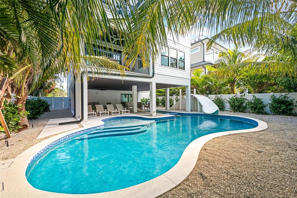 A two-story house with a covered patio, swimming pool, and slide in the backyard — 211 GRANT DRIVE, SARASOTA, FL