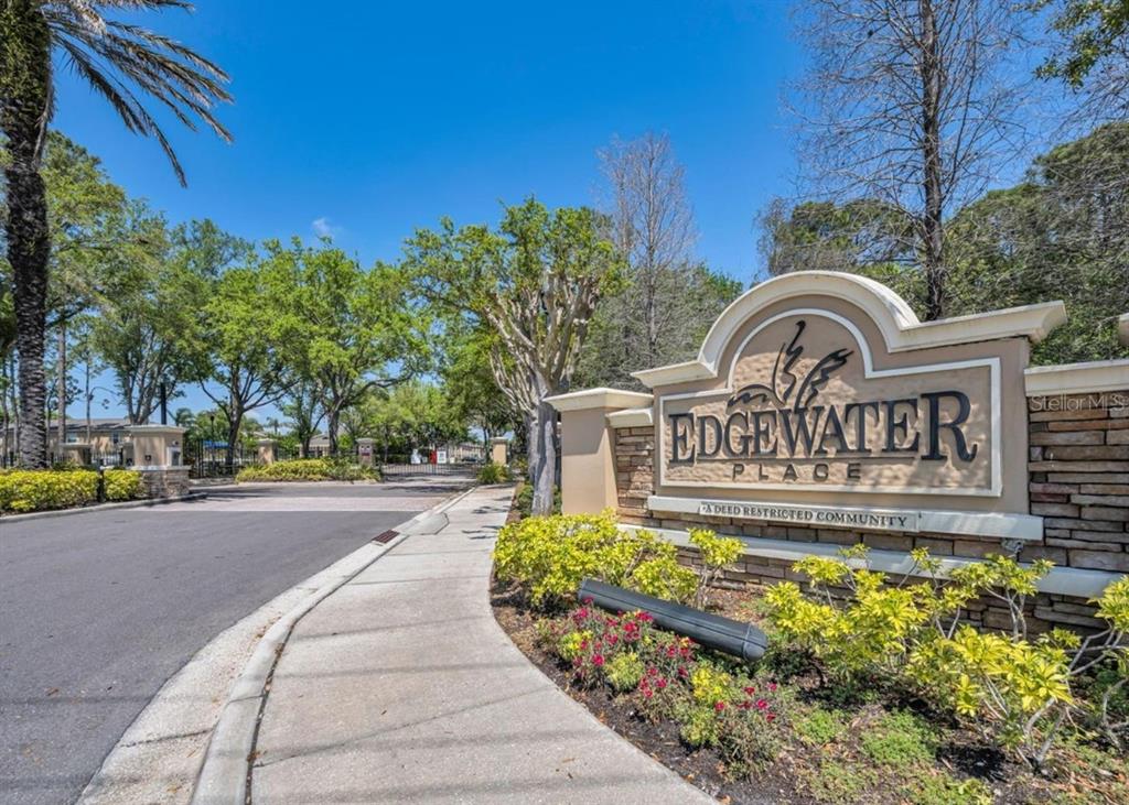 A stone and stucco sign marks the entrance to the Edgewater Place community — 8013 SUTTON TERRACE LANE, TAMPA, FL