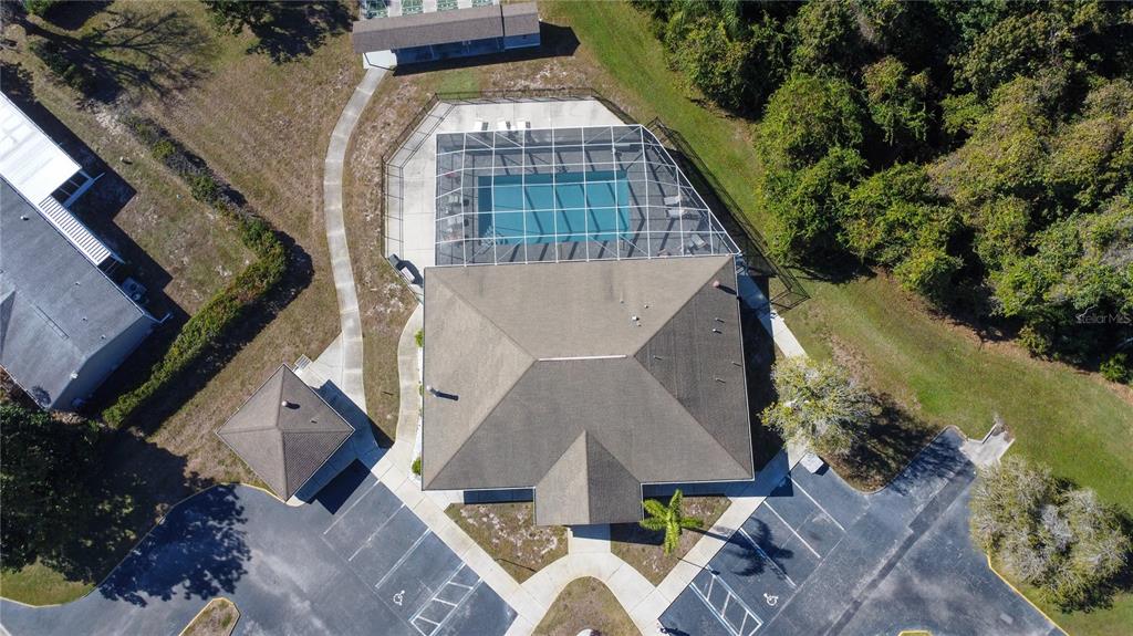 Aerial view of a community clubhouse with a screened pool, parking lot, and gazebo — FOREST GLENN DRIVE, SPRING HILL, FL